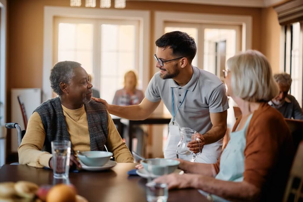 Older adults having dinner at a senior living community