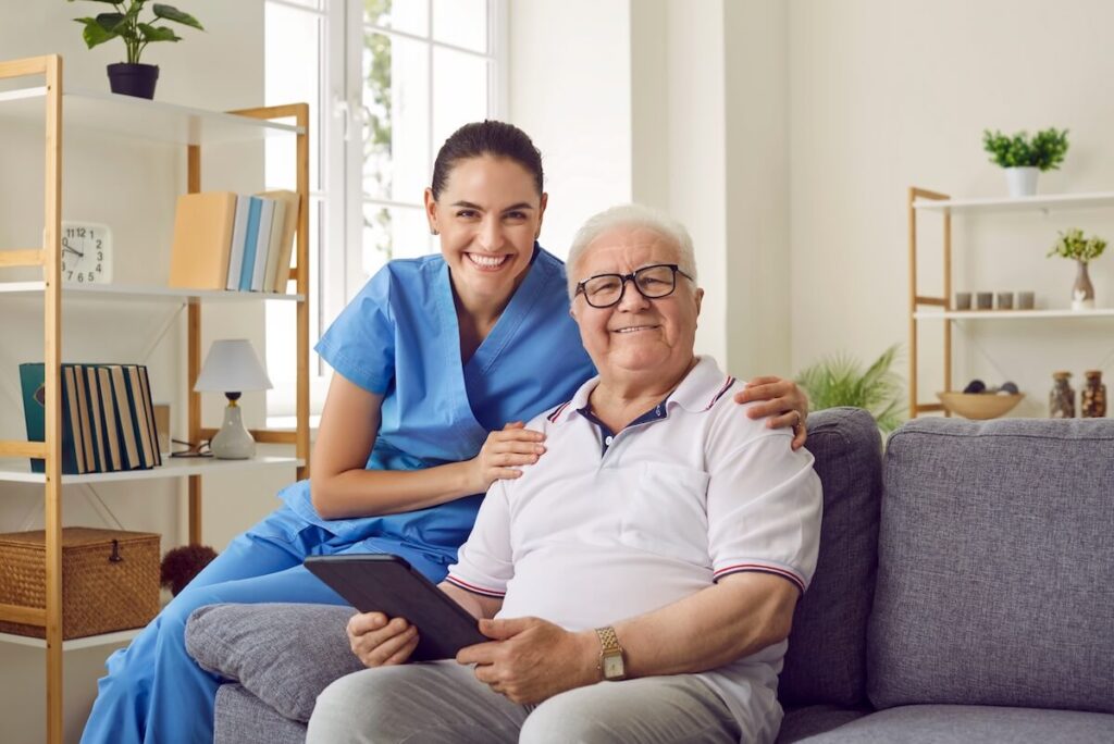 Happy caregiver with a senior at home.