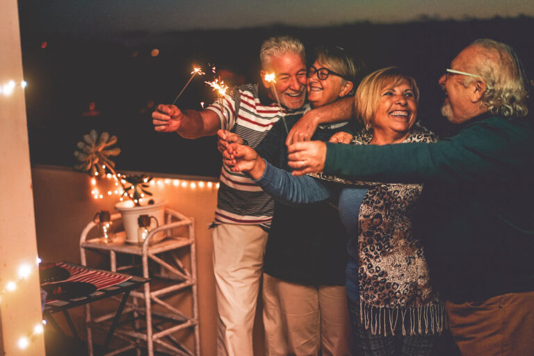 Older adults holding sparklers.